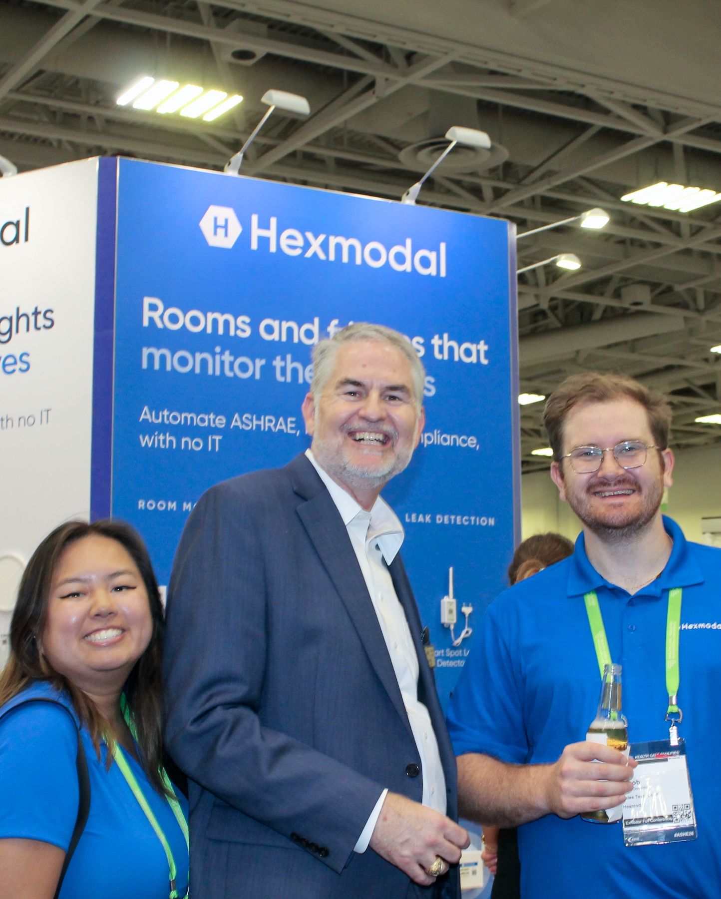 Hexmodal team members with a conference guest at the booth