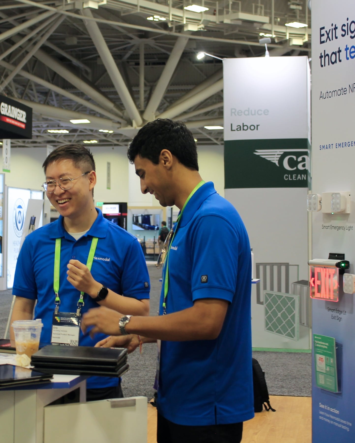 Two Hexmodal team members talking at the booth