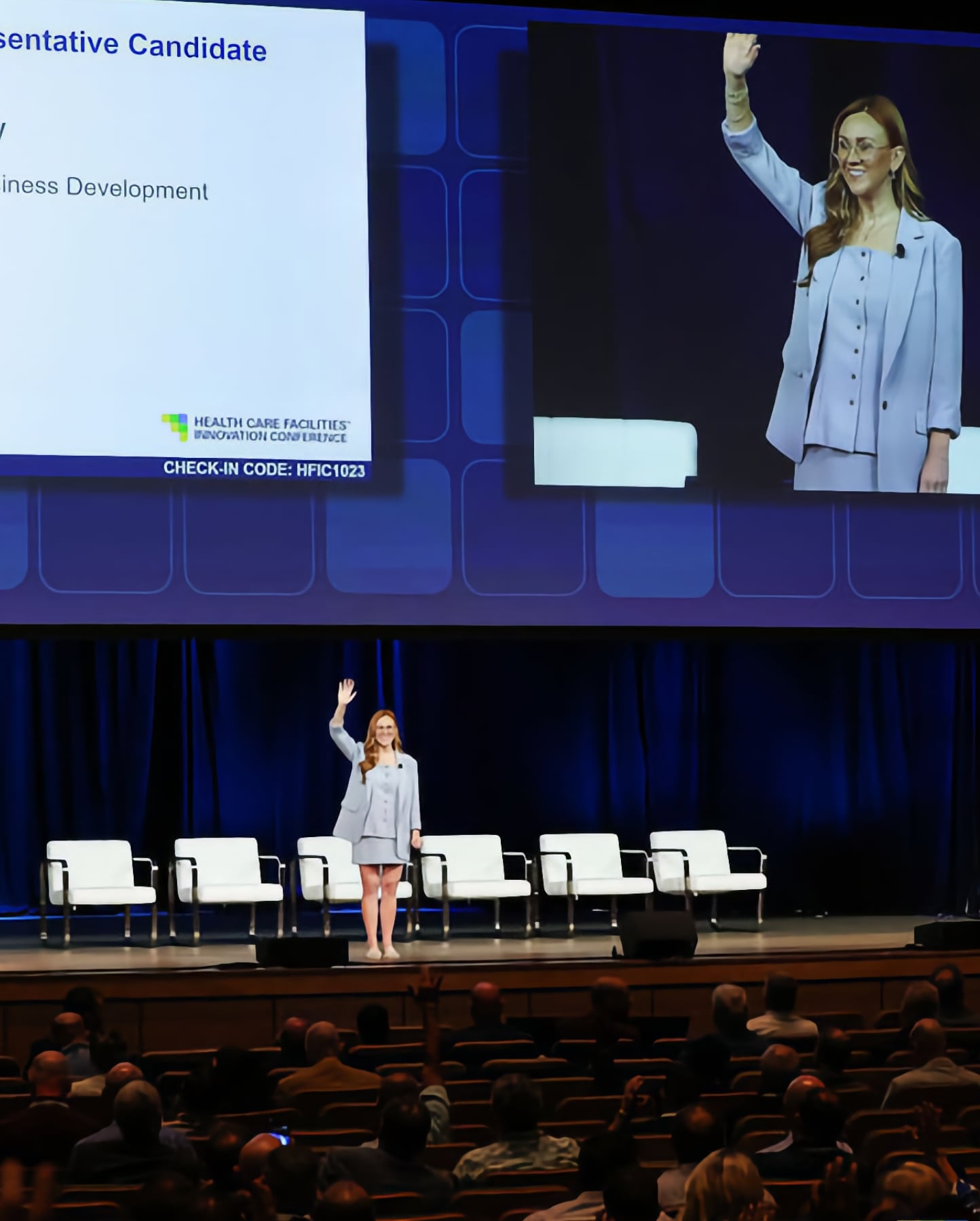 Speaker on stage with the main-stage screens at ASHE HFIC